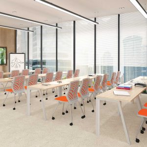 arcline training tables in multiple rows paired with Xera nesting chairs in orange seats.